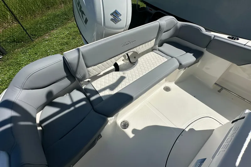 Slide: The Image of 2027 Pioneer 202 Islander boat interior with gray seating and Suzuki engine. - 13