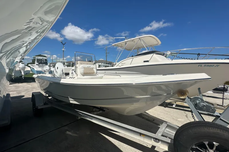 Slide: The Image of 2027 Bulls Bay 2000 XS boat on trailer under clear blue sky. - 2