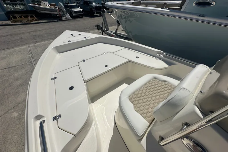 Slide: The Image of 2027 Bulls Bay 2000 XS boat interior with cushioned seating and storage compartments. - 7