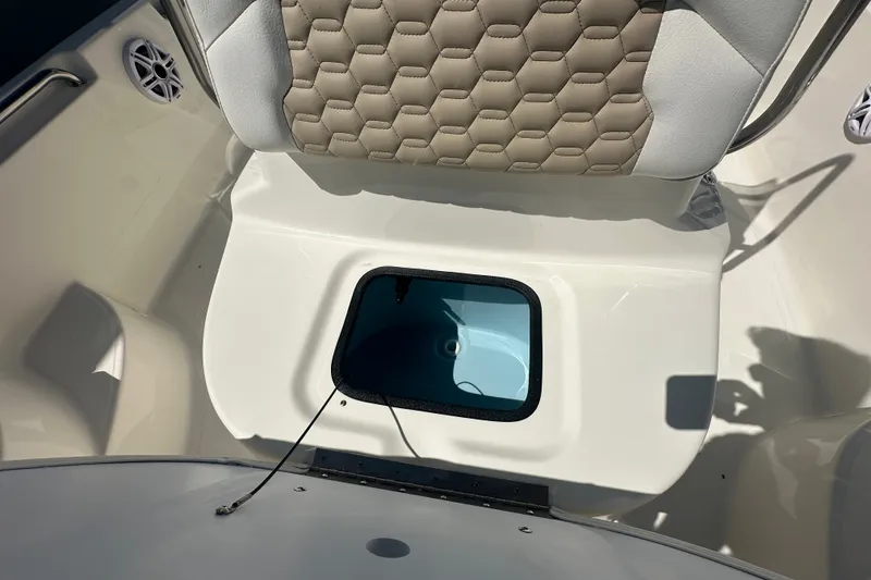 Slide: The Image of 2027 Bulls Bay 2000 XS boat interior with cushioned seating and storage compartment. - 11