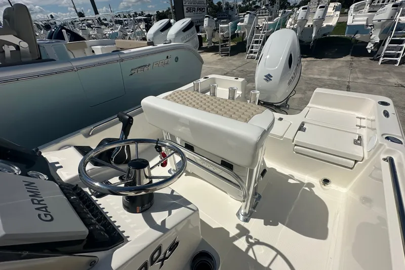 Slide: The Image of 2027 Bulls Bay 2000 XS boat interior with steering wheel and seating. - 12