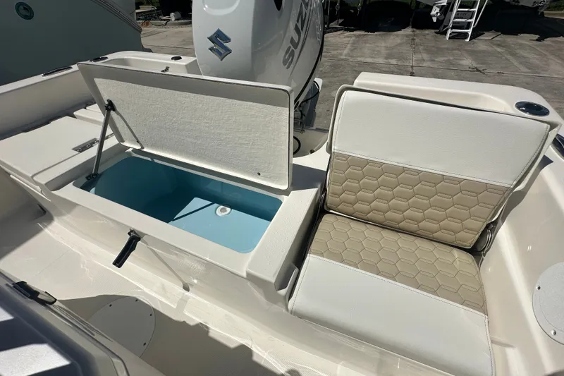 Slide: The Image of 2027 Bulls Bay 2000 XS boat interior with open storage compartment and cushioned seating. - 14