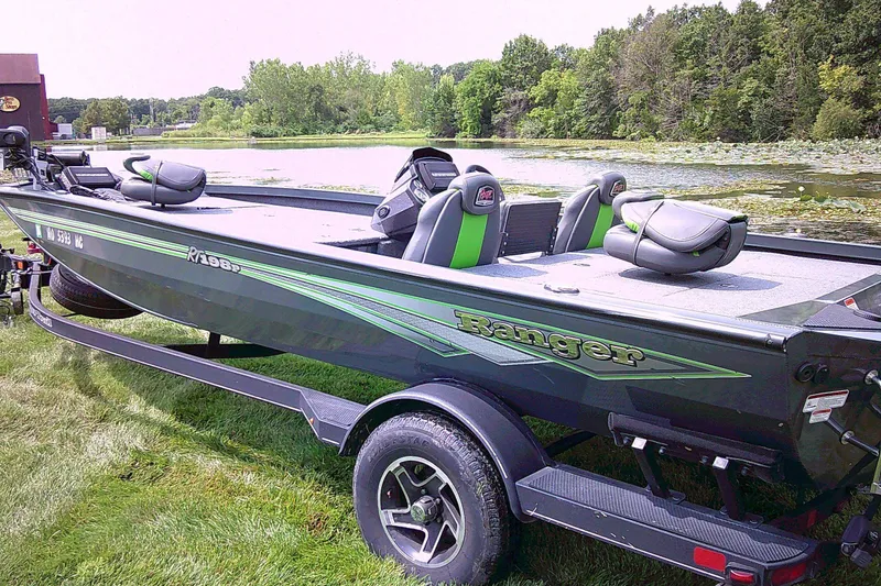 Slide: The Image of 2025 Ranger RT198P fishing boat on trailer by a scenic lake. - 4