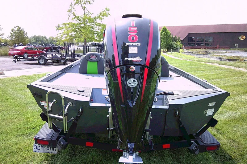 Slide: The Image of 2025 Ranger RT198P boat with 150 Pro outboard motor on grassy area. - 2