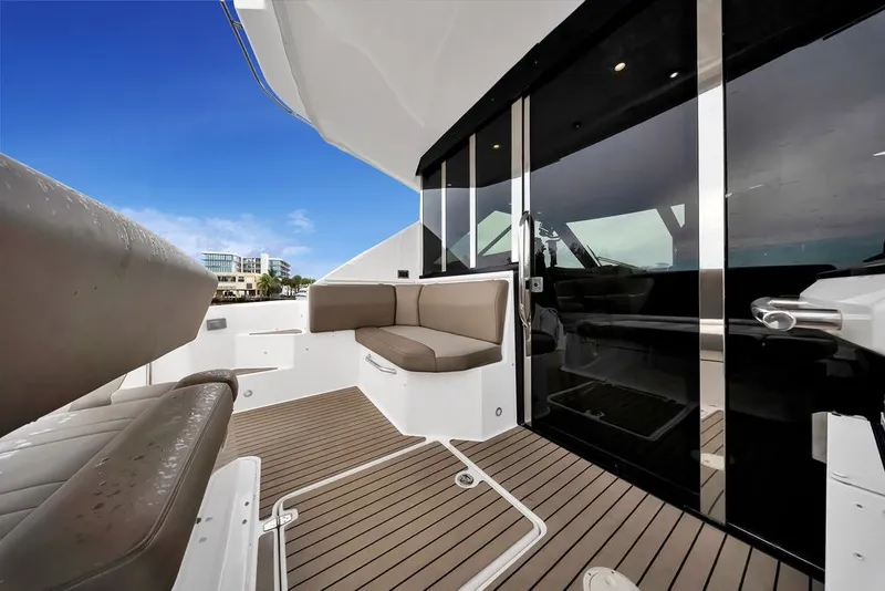 Slide: The Image of 2014 Regal 42 Sport Coupe yacht deck with seating, sleek design, and modern finishes. - 47