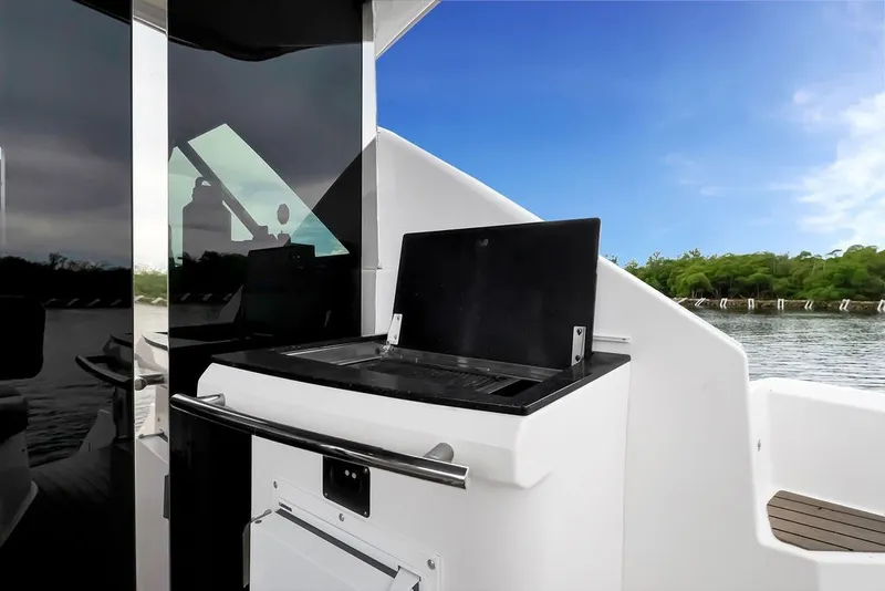 Slide: The Image of Outdoor grill on 2014 Regal 42 Sport Coupe yacht, with scenic water view. - 45
