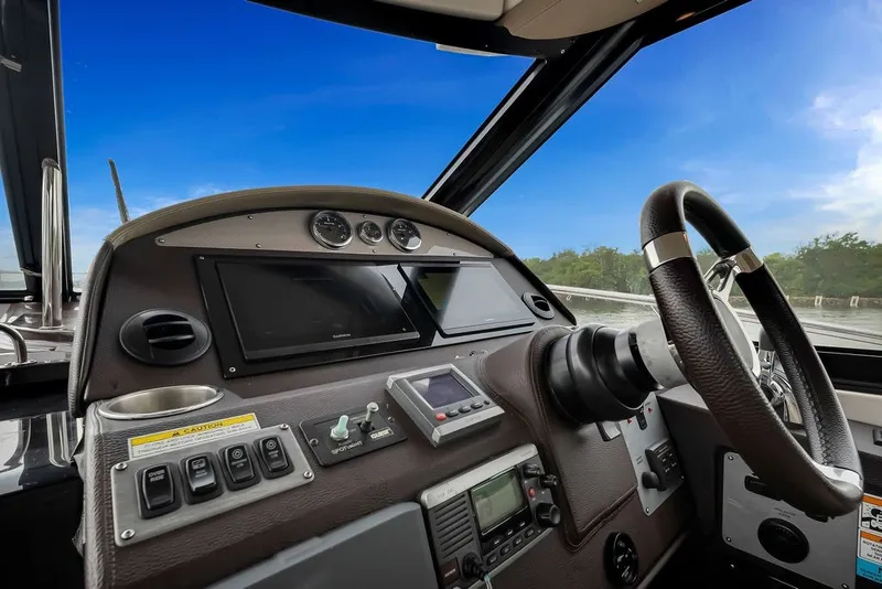 Slide: The Image of Cockpit of 2014 Regal 42 Sport Coupe with steering wheel and navigation controls. - 59
