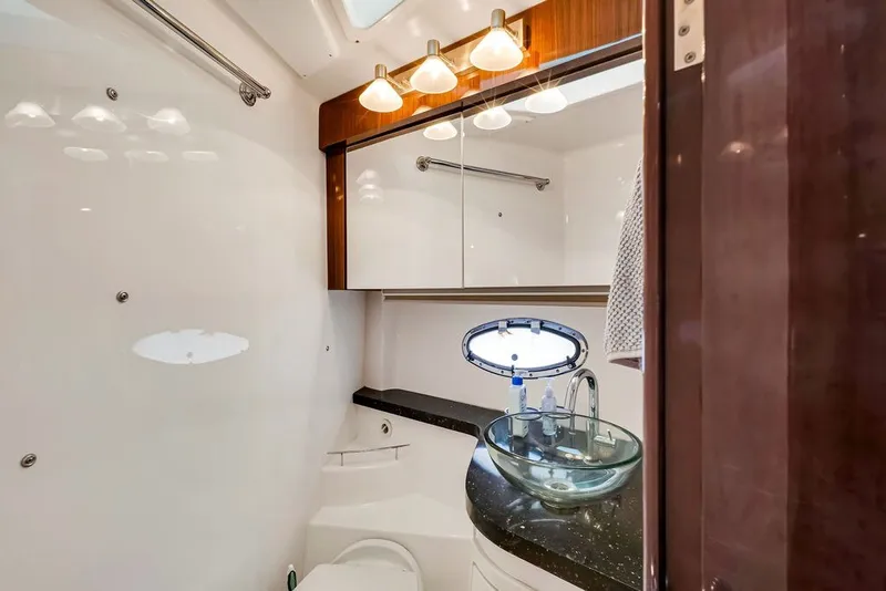 Slide: The Image of Luxurious bathroom in 2014 Regal 42 Sport Coupe yacht with glass sink and elegant lighting. - 14