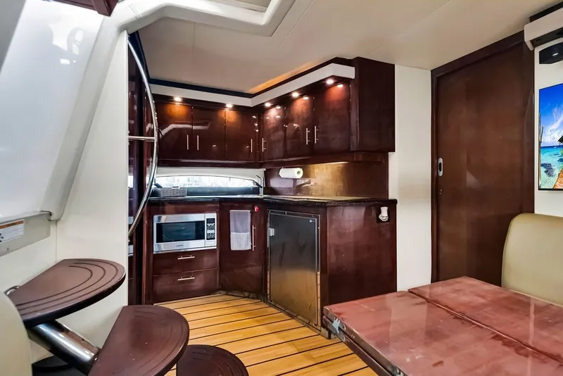 Slide: The Image of Luxurious interior of 2014 Regal 42 Sport Coupe yacht with modern kitchen amenities. - 43