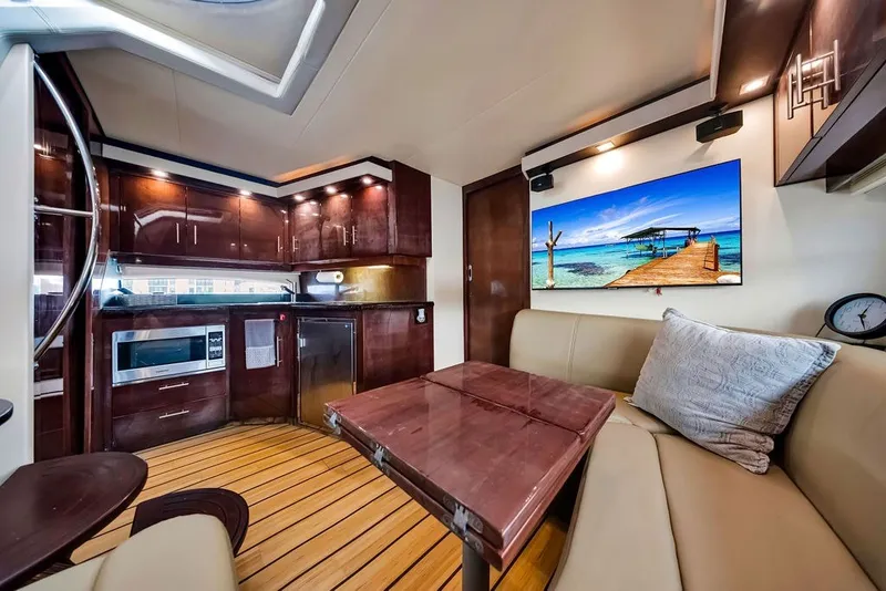 Slide: The Image of Luxurious interior of 2014 Regal 42 Sport Coupe yacht with modern kitchen and cozy seating area. - 42
