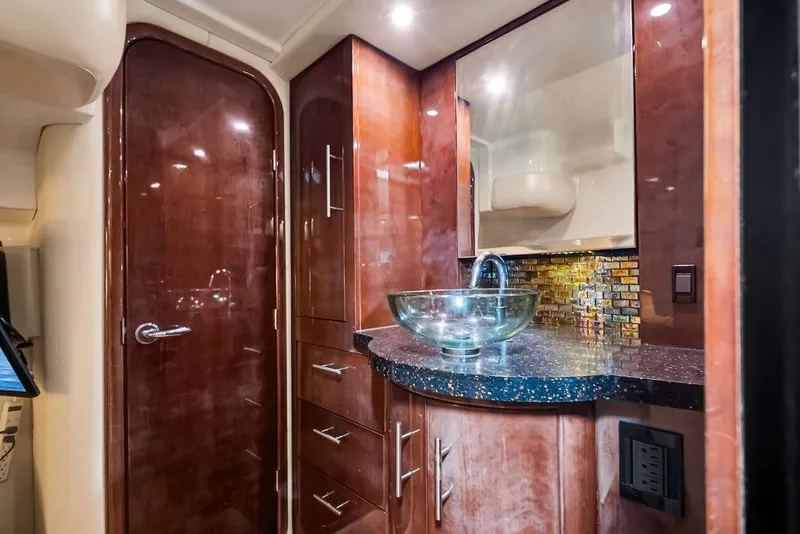 Slide: The Image of Luxurious bathroom interior of 2014 Regal 42 Sport Coupe yacht with glass sink and wood cabinetry. - 16