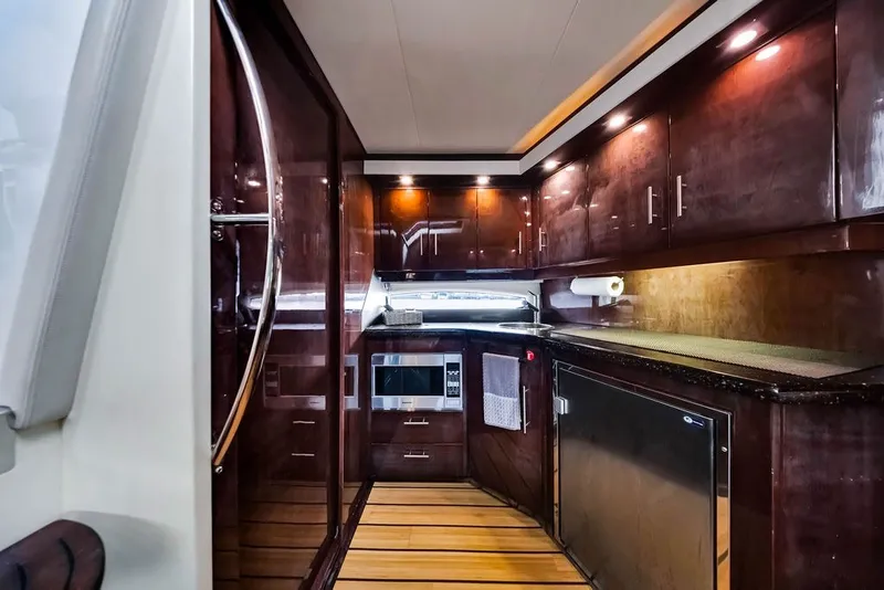 Slide: The Image of Luxurious kitchen interior of 2014 Regal 42 Sport Coupe yacht with wood cabinetry. - 41