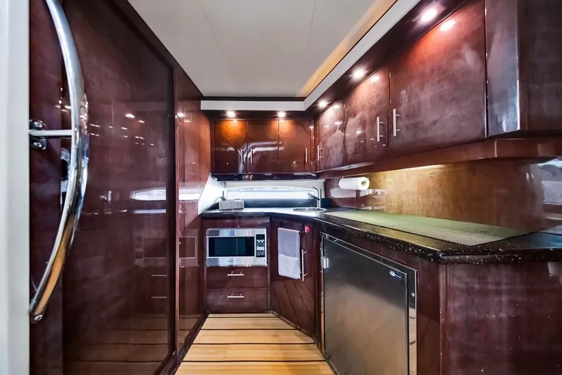 Slide: The Image of Luxurious kitchen interior of 2014 Regal 42 Sport Coupe yacht with wood cabinetry. - 40