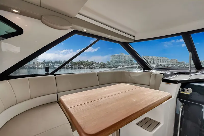 Slide: The Image of Luxurious interior of 2014 Regal 42 Sport Coupe yacht with panoramic windows and seating. - 55