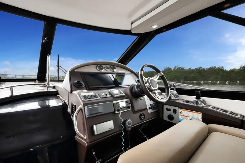 Slide: The Image of Interior cockpit of 2014 Regal 42 Sport Coupe yacht with modern controls. - 58