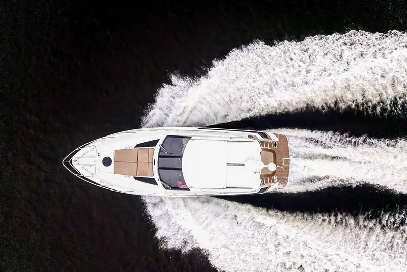 Slide: The Image of Top view of a 2014 Regal 42 Sport Coupe yacht cruising on water. - 28