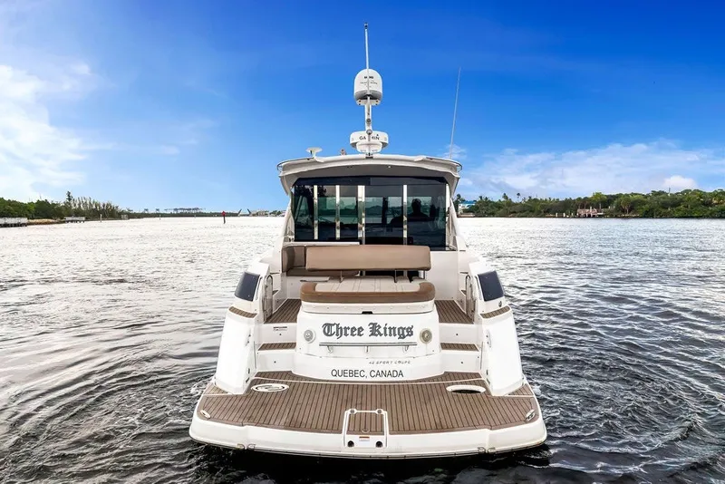 Slide: The Image of 2014 Regal 42 Sport Coupe yacht on water, rear view, clear sky. - 25