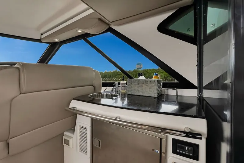 Slide: The Image of Interior of 2014 Regal 42 Sport Coupe yacht with kitchenette and sleek design. - 54