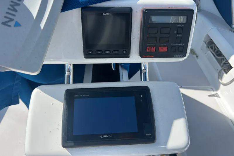 Slide: The Image of Cockpit navigation instruments on a 1997 Catalina 380 sailboat, featuring Garmin and Autohelm displays. - 22