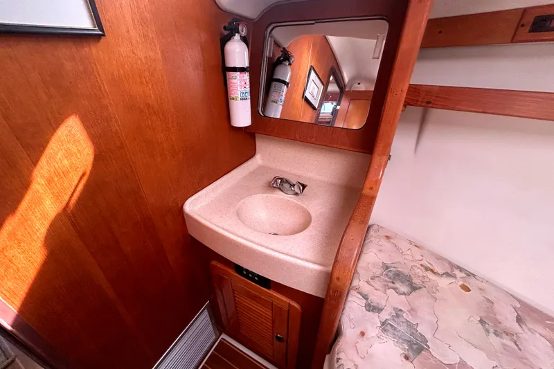 Slide: The Image of Small bathroom sink area in a 1997 Catalina 380 sailboat cabin. - 14