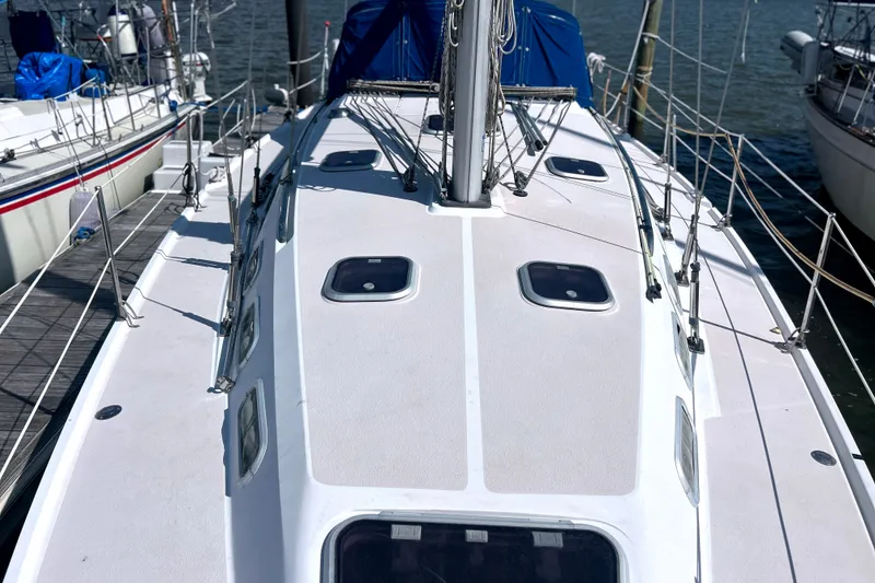 Slide: The Image of Deck view of a 1997 Catalina 380 sailboat docked at a marina. - 19