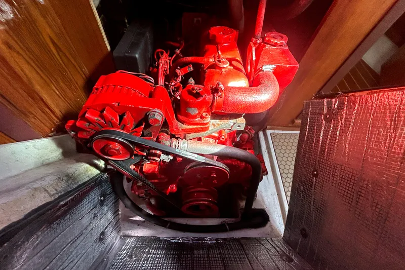 Slide: The Image of Red engine inside a 1997 Catalina 380 sailboat, showcasing mechanical components. - 18