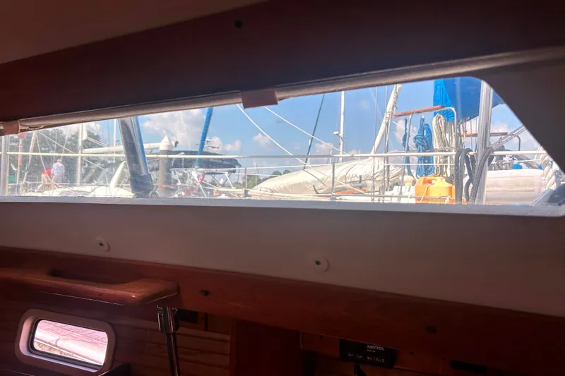 Slide: The Image of View from inside a 1997 Catalina 380 sailboat, showing marina and rigging outside. - 20
