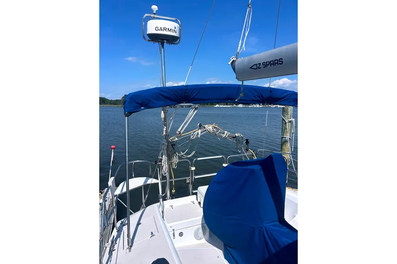 Slide: The Image of Sailboat cockpit view of a 1997 Catalina 380 with Garmin equipment, docked by calm waters. - 16