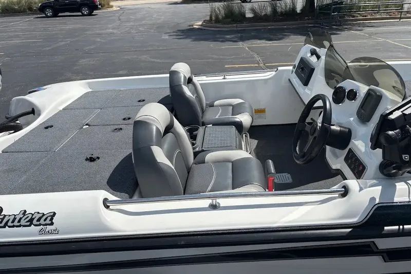 Slide: The Image of 2004 Bass Cat Pantera Classic boat interior with gray seating and steering console. - 4