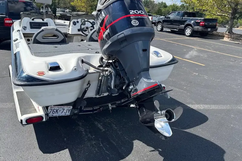 Slide: The Image of 2004 Bass Cat Pantera Classic boat with Yamaha 200 HP engine in parking lot. - 2