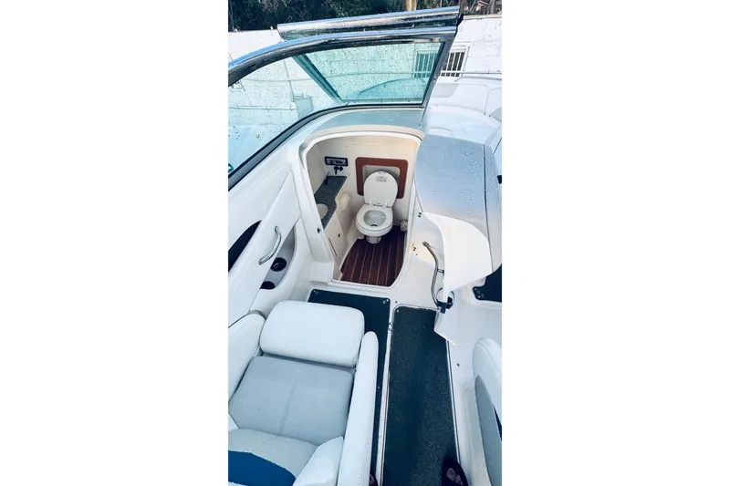 Slide: The Image of 2007 Chaparral 276 SSX boat interior with a compact marine toilet. - 4