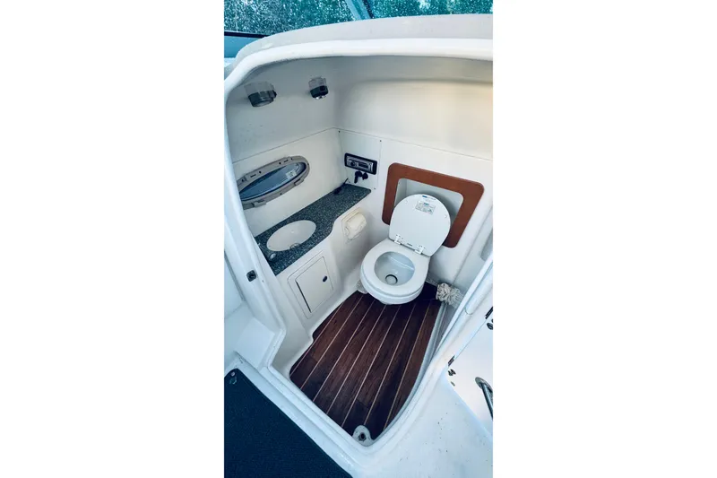 Slide: The Image of 2007 Chaparral 276 SSX boat bathroom with toilet, sink, and wooden flooring. - 6