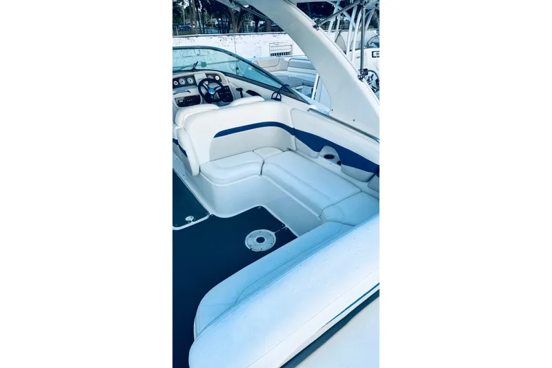 Slide: The Image of 2007 Chaparral 276 SSX boat interior with white and blue seating, steering console visible. - 2