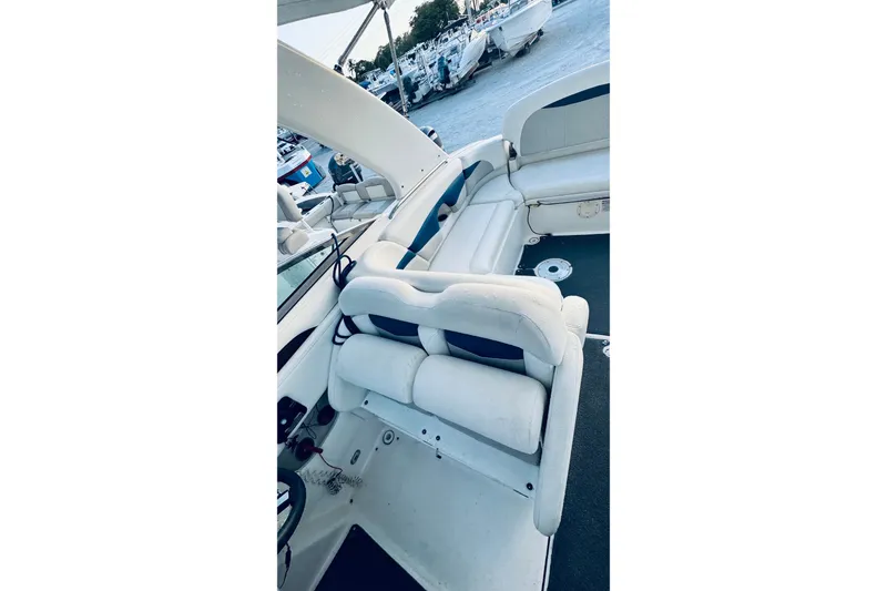 Slide: The Image of 2007 Chaparral 276 SSX boat interior with white seating and steering wheel. - 12