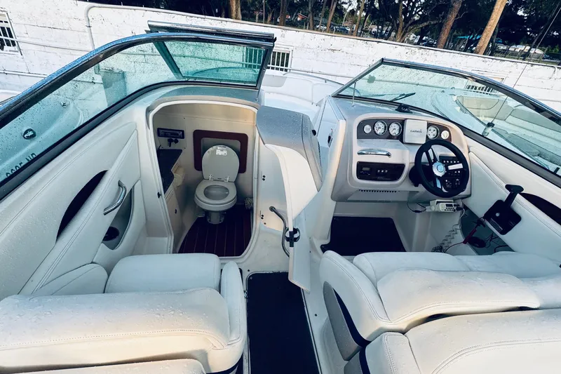 Slide: The Image of 2007 Chaparral 276 SSX boat interior with helm and compact toilet area. - 5