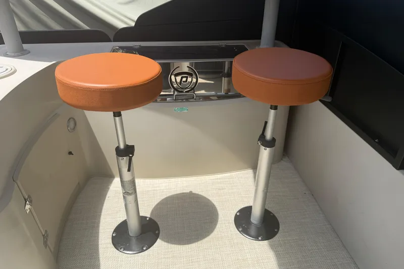 Slide: The Image of Two orange bar stools on a 2015 Premier 290 Grand View boat. - 78