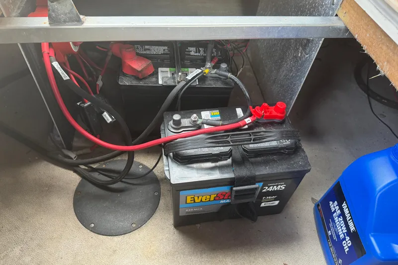 Slide: The Image of Battery compartment of a 2015 Premier 290 Grand View with EverStart battery and engine oil. - 83