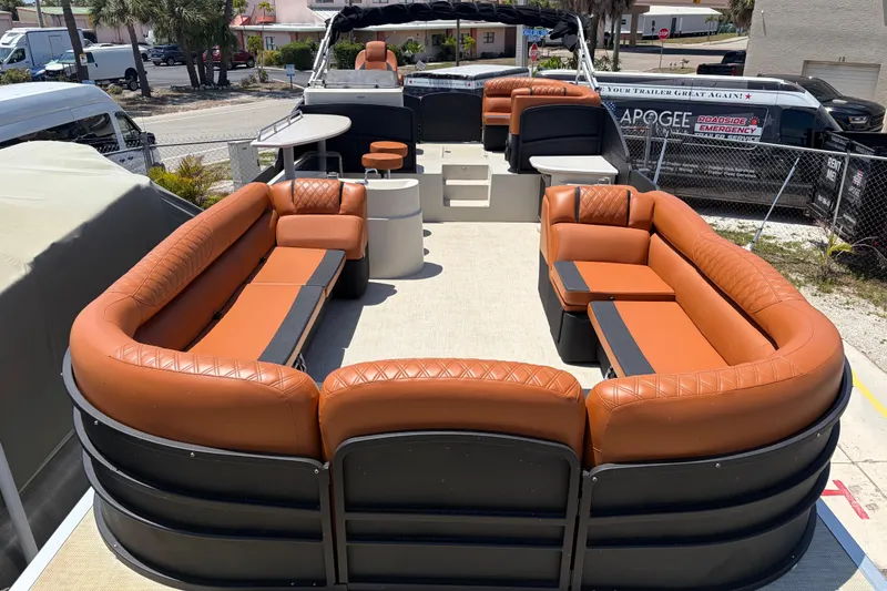 Slide: The Image of 2015 Premier 290 Grand View pontoon boat with luxurious orange seating and spacious deck layout. - 20