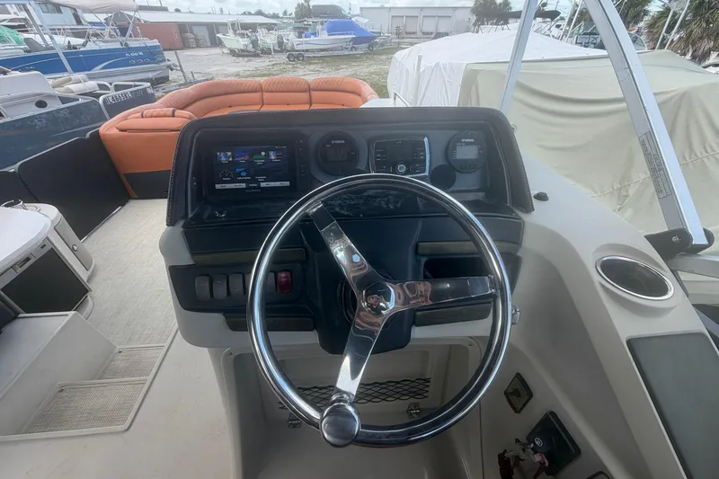 Slide: The Image of Steering console of a 2015 Premier 290 Grand View boat with dashboard controls. - 64
