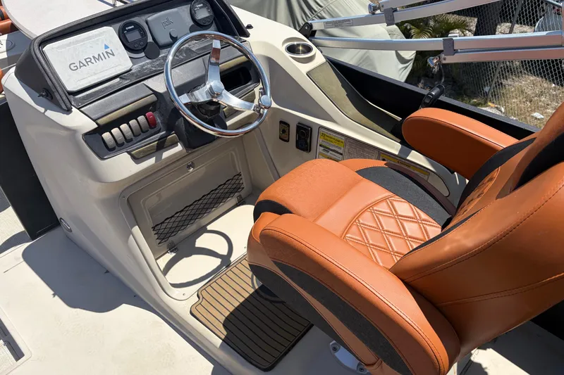 Slide: The Image of Captain's chair and dashboard of 2015 Premier 290 Grand View boat with Garmin navigation. - 35