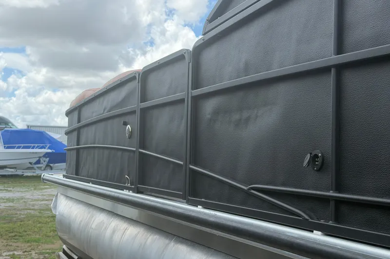 Slide: The Image of 2015 Premier 290 Grand View pontoon boat side view under cloudy sky. - 19