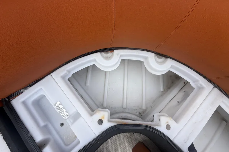 Slide: The Image of Interior storage compartment of 2015 Premier 290 Grand View boat with brown seating. - 53