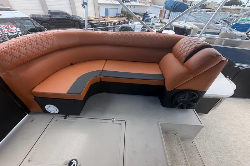 Slide: The Image of Luxurious seating on 2015 Premier 290 Grand View pontoon boat, featuring brown leather upholstery. - 28