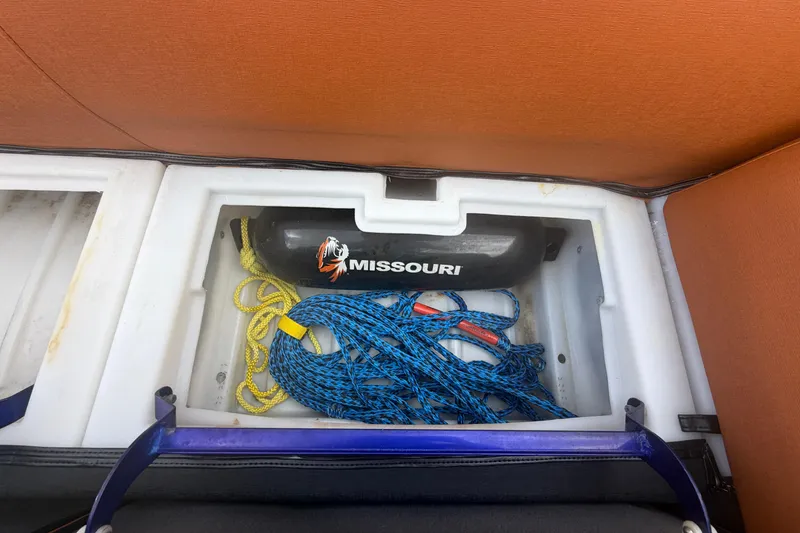 Slide: The Image of Storage compartment in a 2015 Premier 290 Grand View boat with ropes and a Missouri fender. - 49