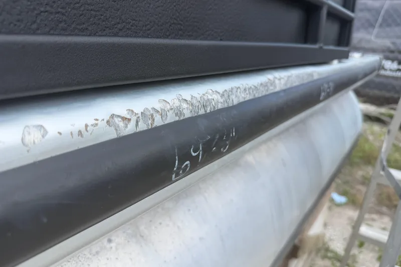 Slide: The Image of Close-up of a 2015 Premier 290 Grand View pontoon with visible wear and scratches. - 17