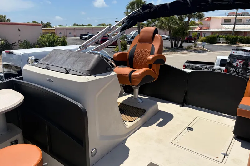 Slide: The Image of Captain's chair on 2015 Premier 290 Grand View boat, docked in sunny marina. - 37