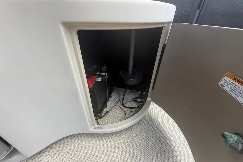 Slide: The Image of Open compartment in 2015 Premier 290 Grand View boat showing battery and wiring. - 73