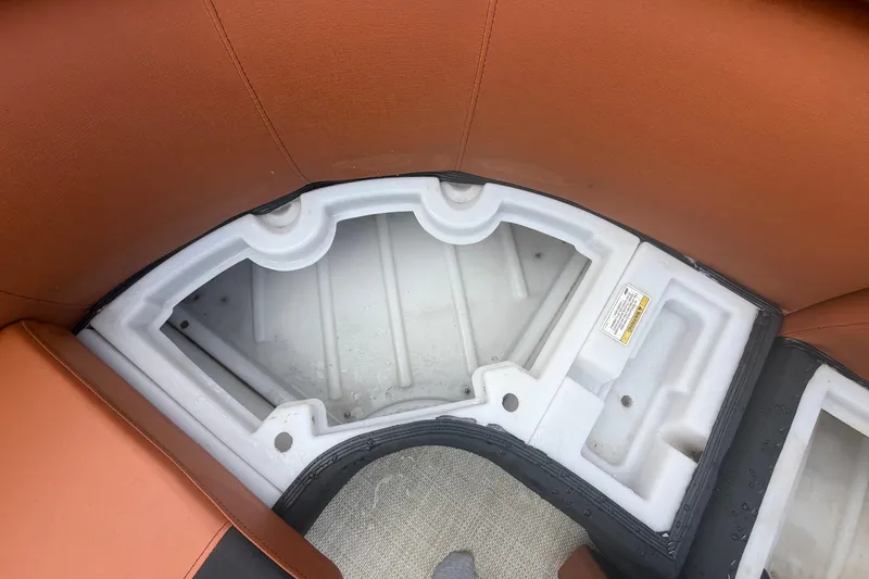 Slide: The Image of Storage compartment in 2015 Premier 290 Grand View boat with brown seating. - 52