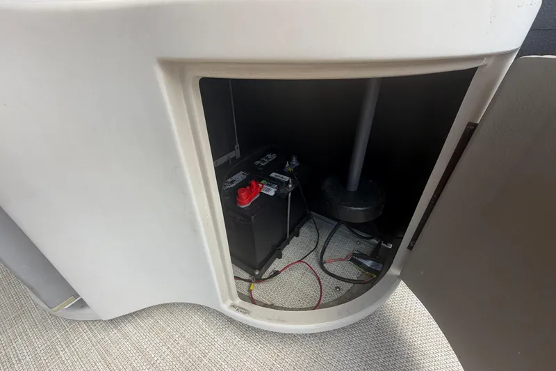 Slide: The Image of Battery compartment of a 2015 Premier 290 Grand View boat, showing wiring and connections. - 74