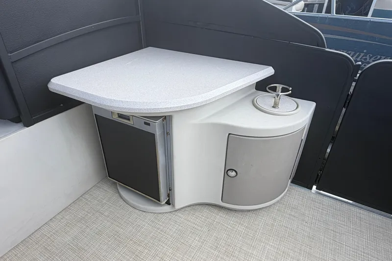 Slide: The Image of 2015 Premier 290 Grand View boat interior with a compact kitchenette and storage. - 62